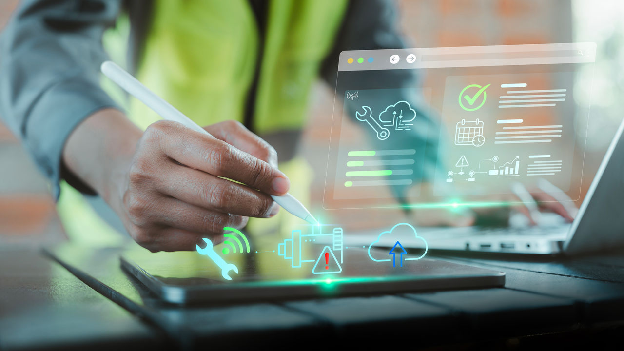 Engineer hand using stylus on tablet with predictive maintenance dashboard UI hologram for industrial IoT concept, Zero downtime, OEE Overall Equipment Effectiveness, Sensor network, Efficiency Safety